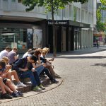 People sitting and looking at their phones