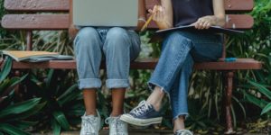 https://www.pexels.com/photo/diverse-students-using-laptop-for-teamwork-on-bench-5538591/