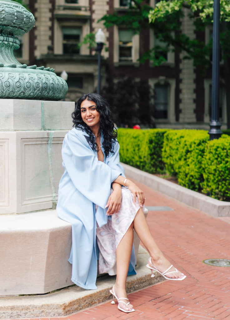 a smiling person sitting in a park