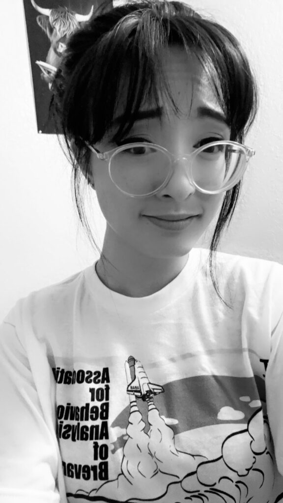 A woman with glasses smiling